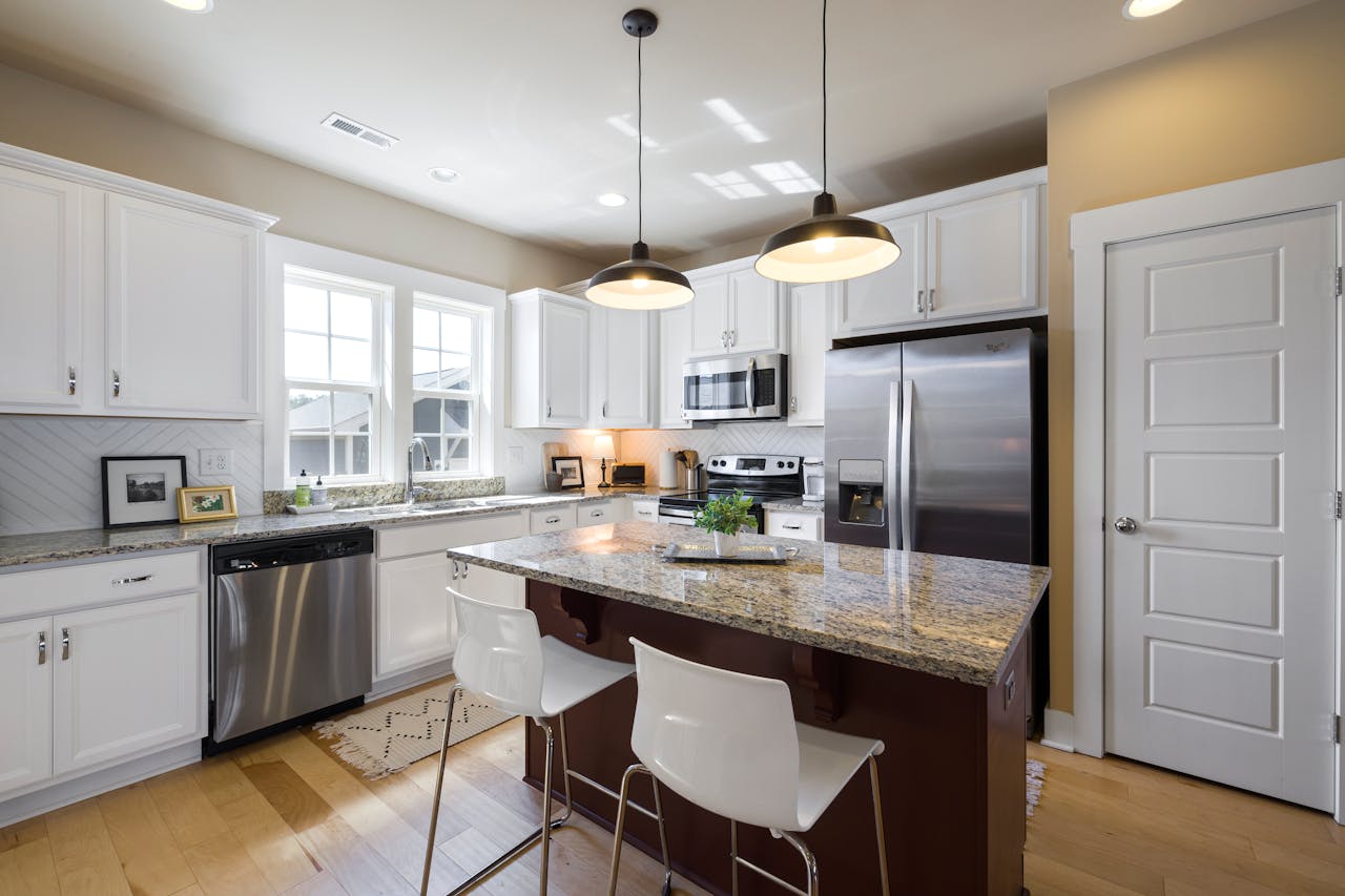Sleek and modern kitchen design featuring a center island and stainless steel appliances.